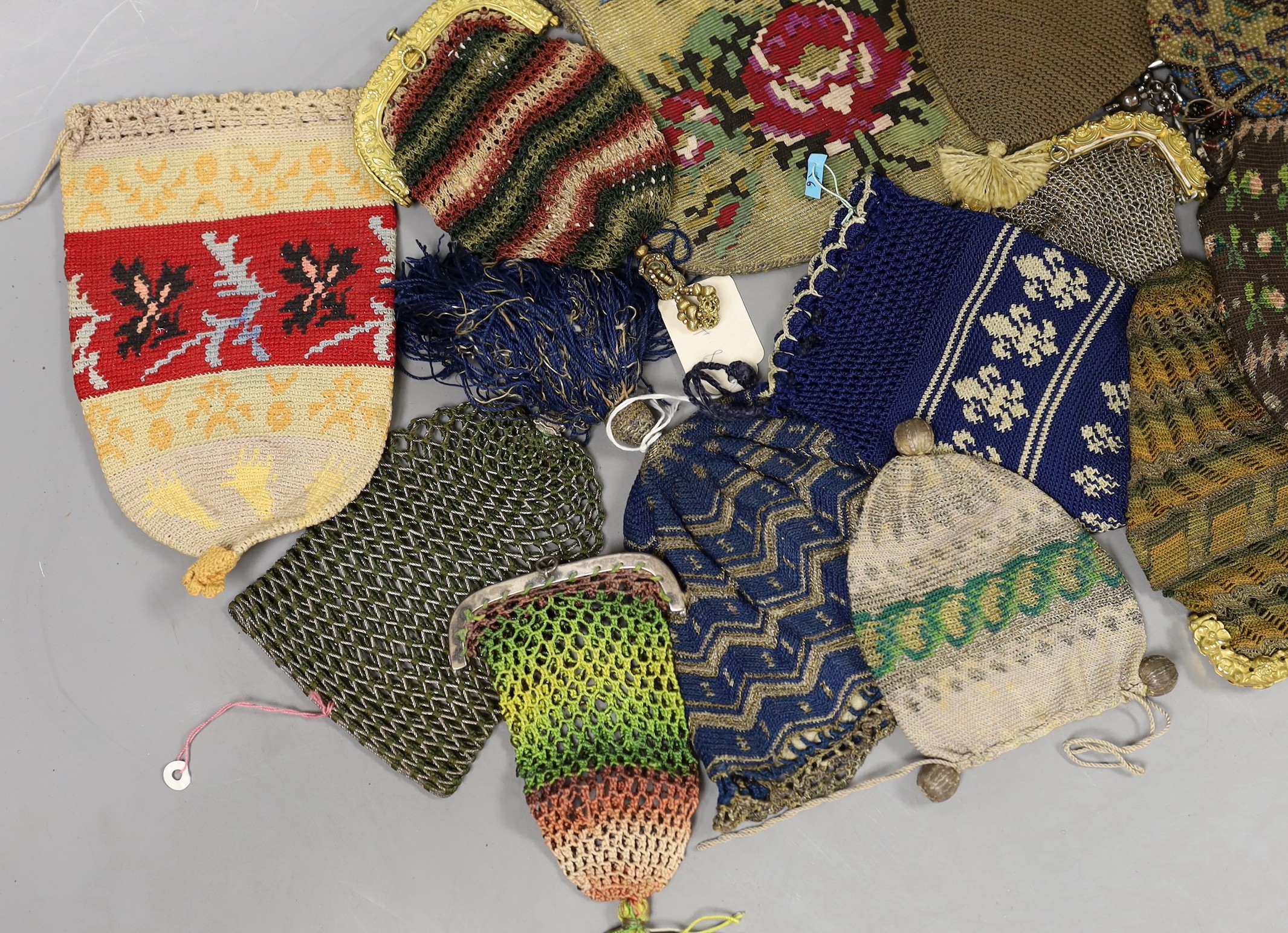 Sixteen mixed 19th century knitted and crochet purses, misers purses, reticules and a woven gilt metal bible bag